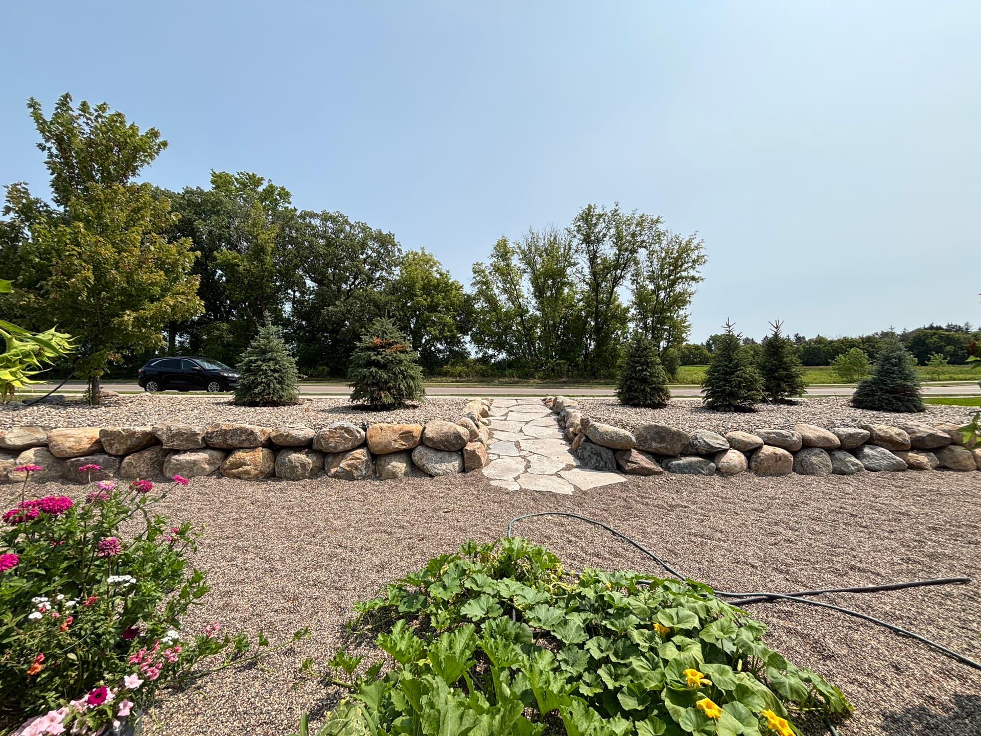 Boulder Walls and Natural Stone Walkway Turn a Sloped Hillside Into Usable Space image